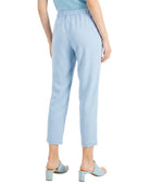 Light blue pants worn by a person on a white background