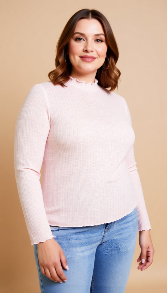 Woman wearing a light pink sweater and blue jeans against a beige background