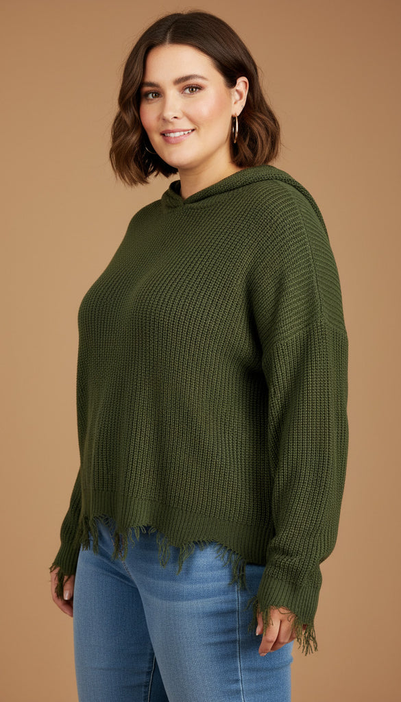 Woman wearing a green sweater and blue jeans on a beige background