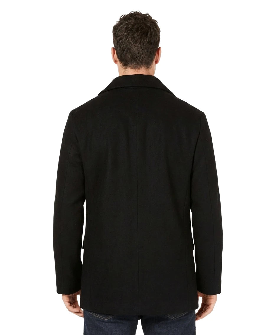 Man wearing a black coat from behind on a white background