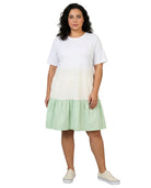 Woman wearing a white and green dress on a white background