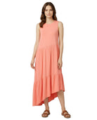 Woman wearing a coral dress on a white background