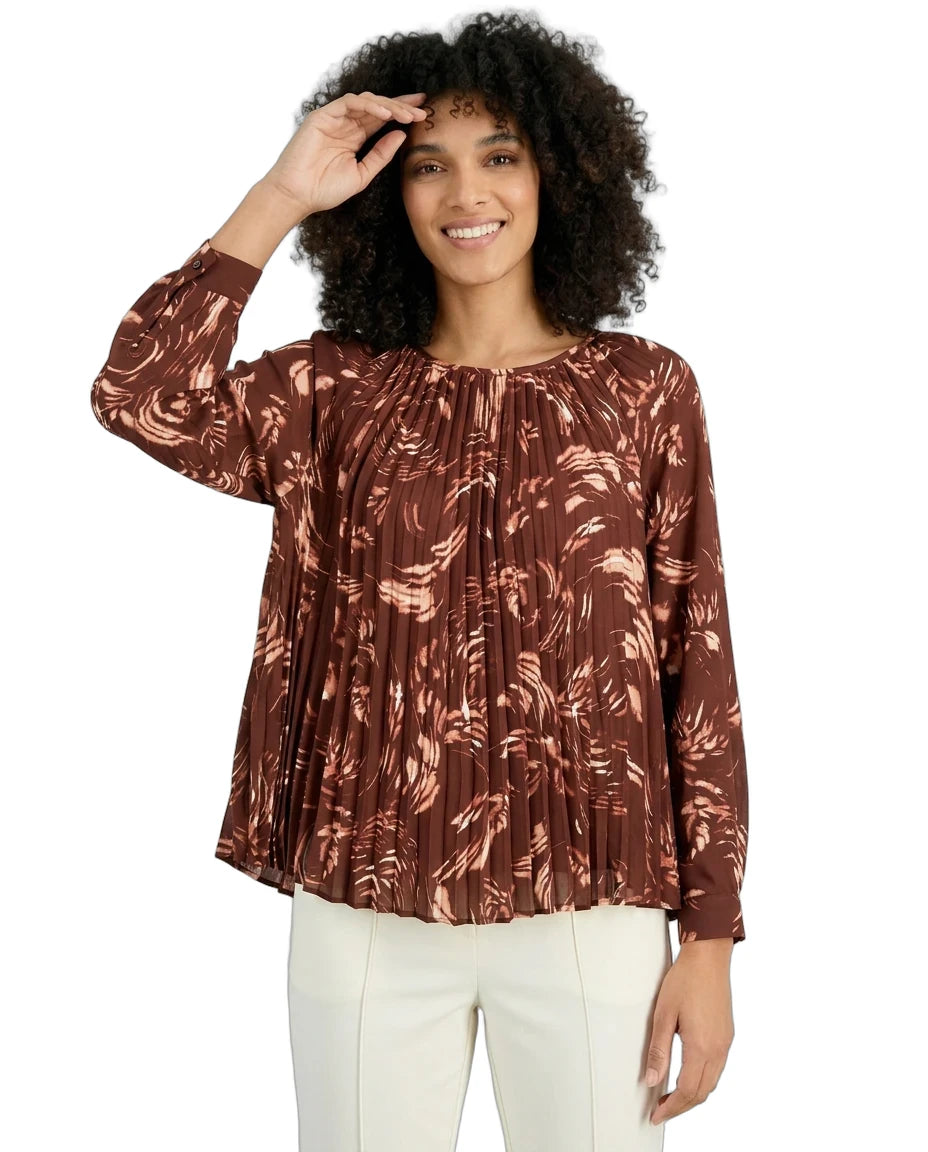 Woman wearing a brown patterned blouse on a white background