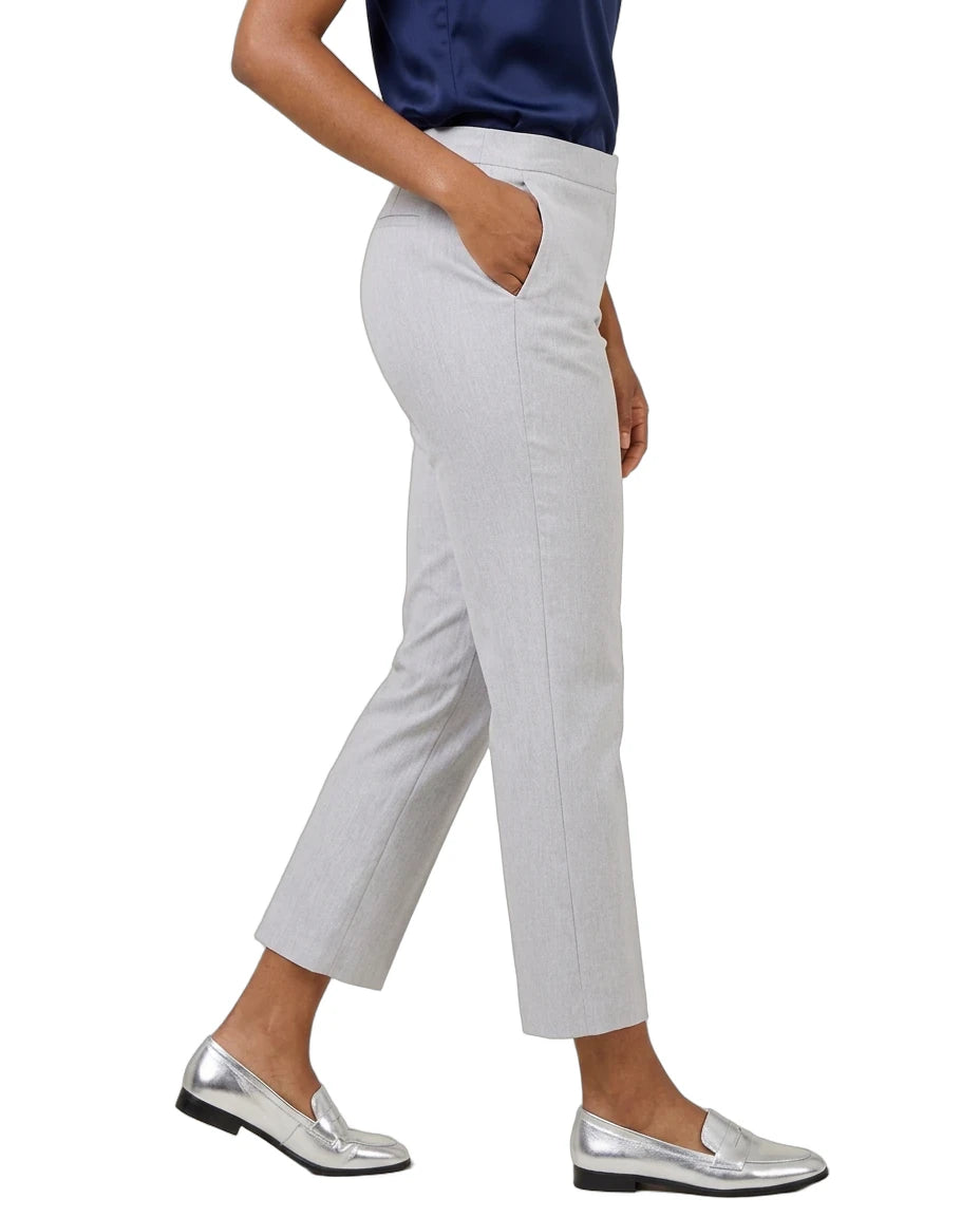 A person wearing light gray cropped trousers with side pockets, paired with a navy top and metallic silver loafers, shown against a plain white background.