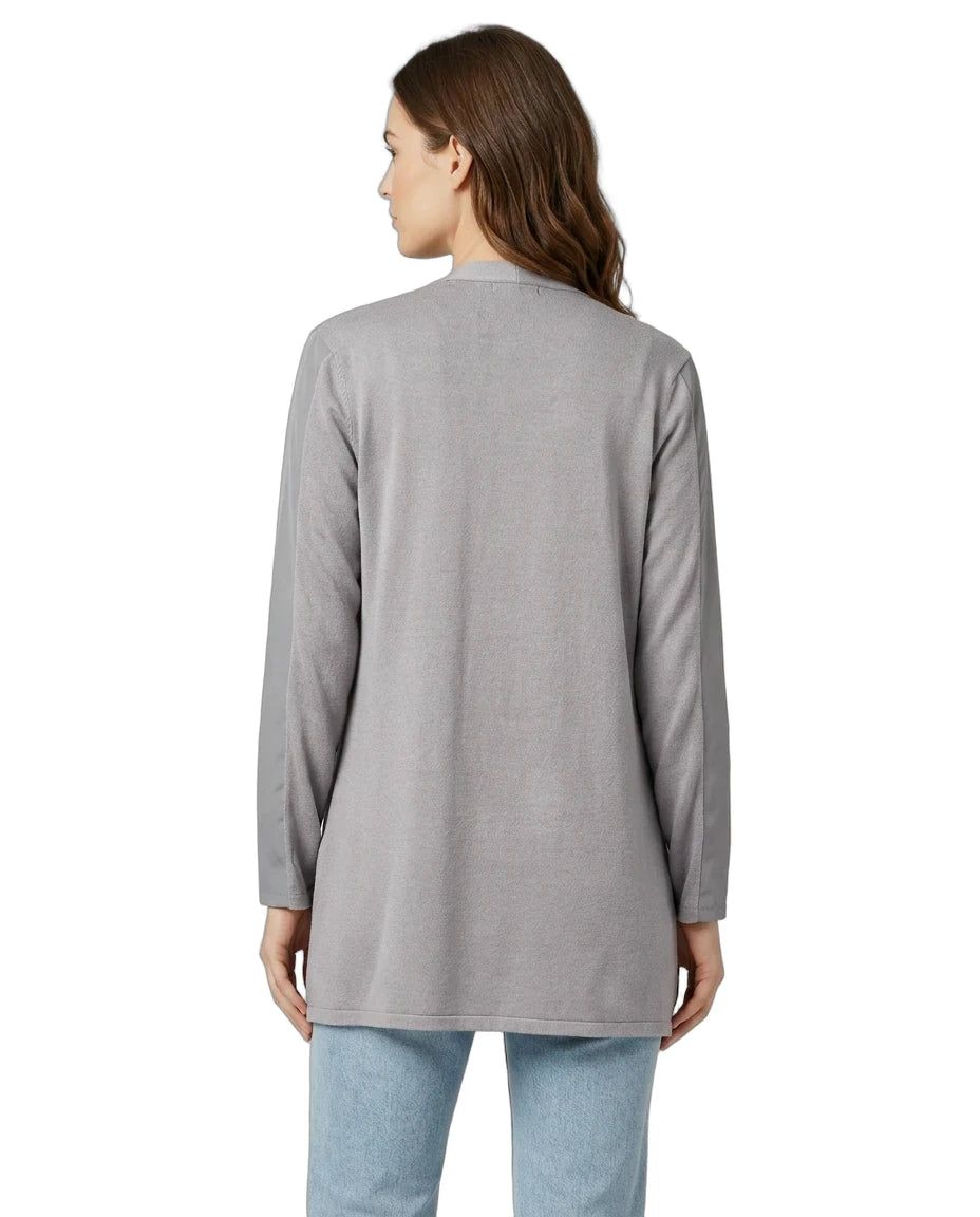 Woman wearing a gray long-sleeve top on a white background