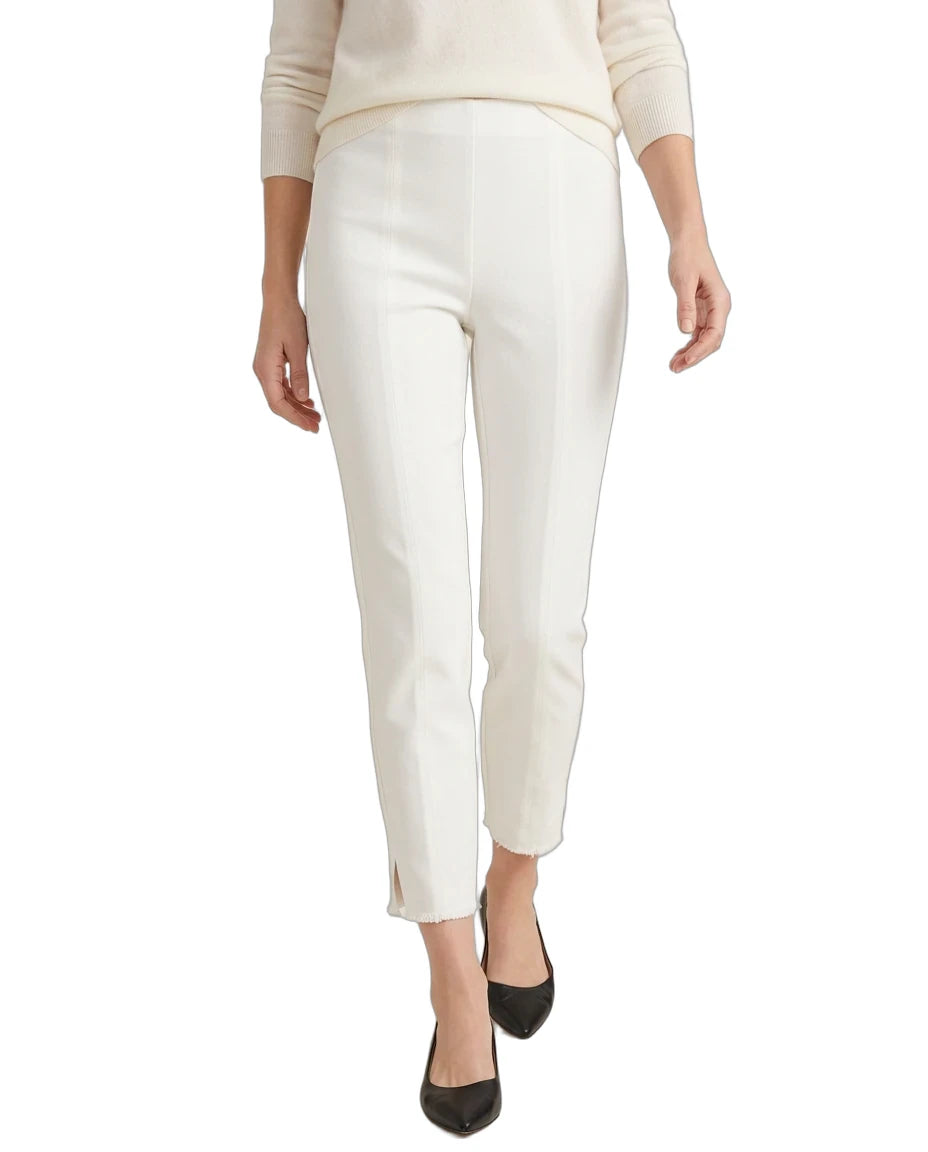 A model wearing a pair of off-white cropped trousers with a slight sheen, styled with a cream sweater and black pointed-toe heels against a plain white background.