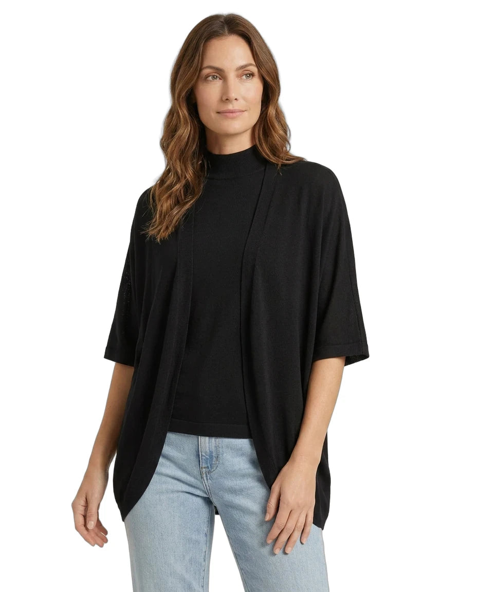 Woman wearing a black top and light blue jeans on a white background
