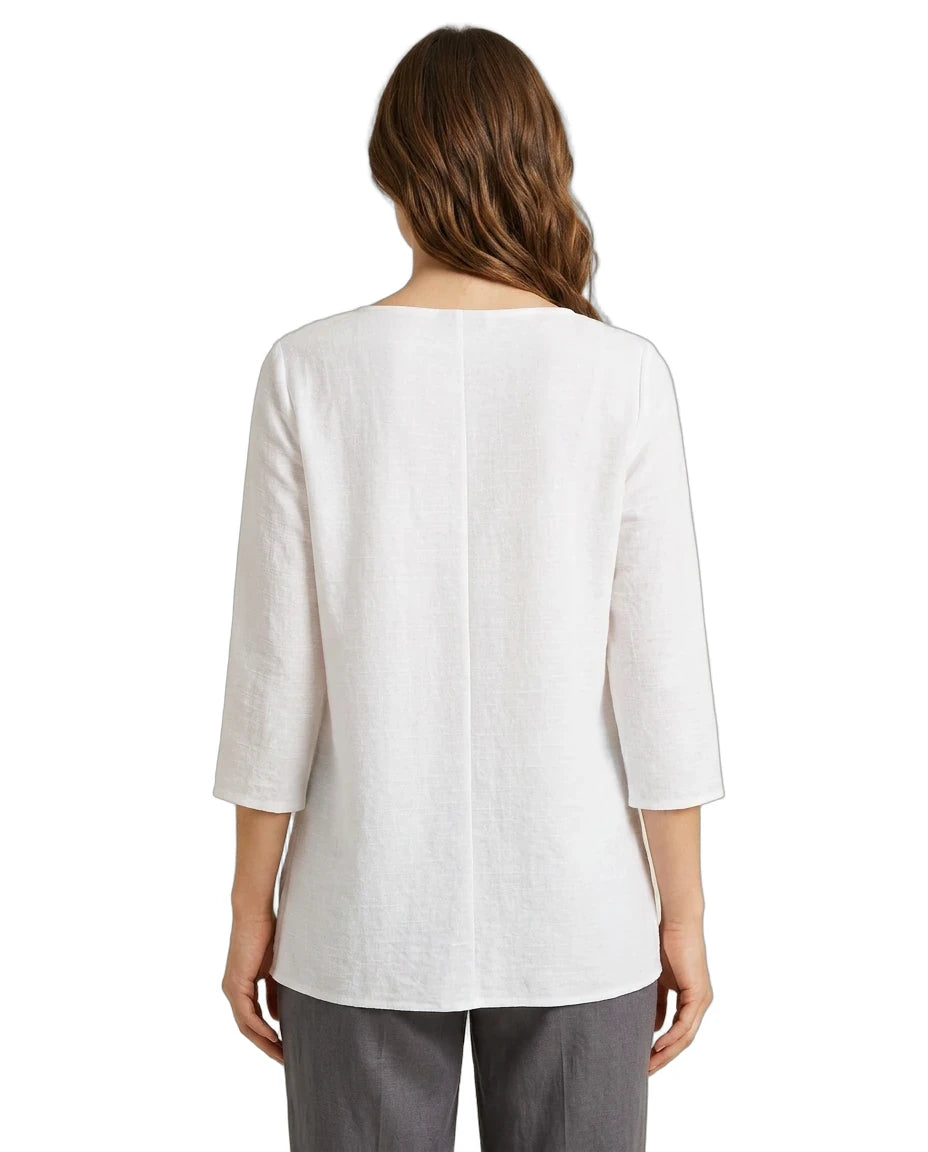 Woman wearing a white blouse with a three-quarter sleeve on a white background