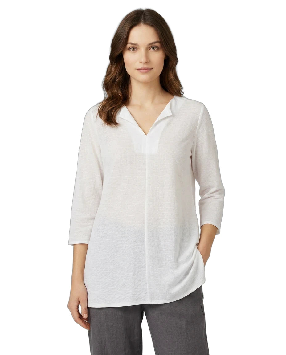 Woman wearing a white blouse with a V-neck and 3/4 sleeves on a white background