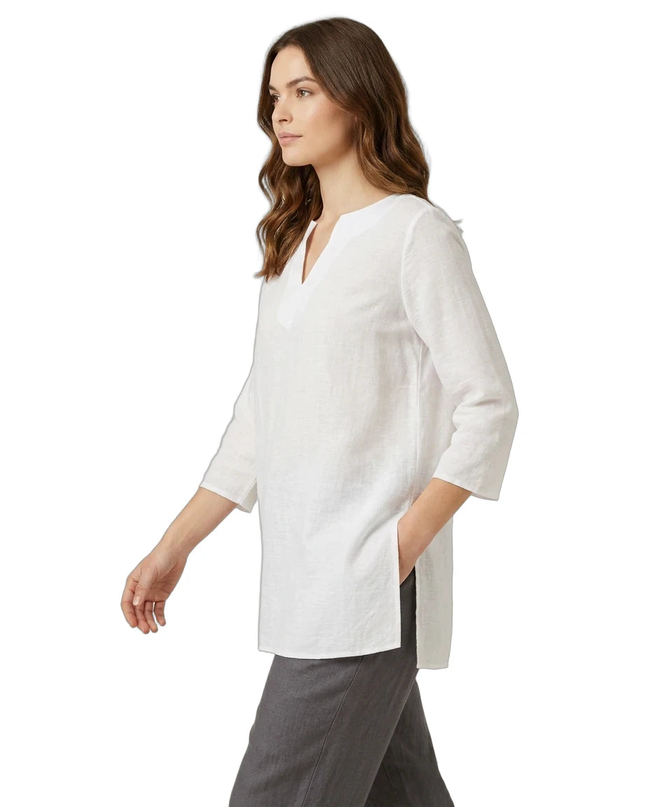Woman wearing a white blouse with a V-neck and three-quarter sleeves on a white background