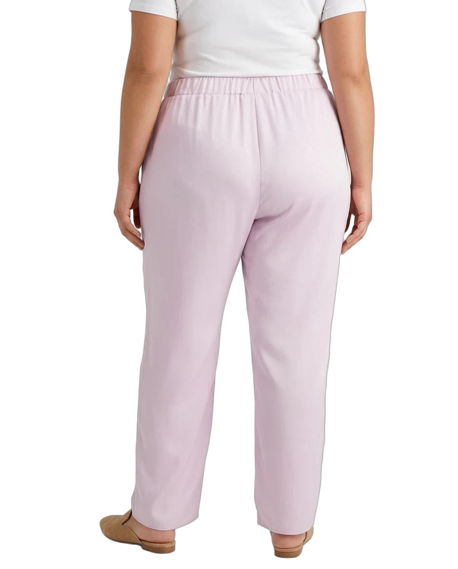 A person shown from the back wearing light pink wide-leg trousers with an elastic waistband, paired with a white top and tan flat shoes, against a plain white background.