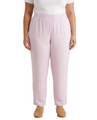 A model wearing light pink wide-leg cropped pants with an elastic waistband, paired with a white top and tan shoes, shown against a plain white background.