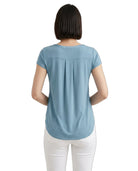 Woman wearing a light blue t-shirt on a white background