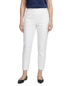 A model wearing white cropped trousers with a straight-leg fit, paired with a navy top and black flats, shown against a plain white background.