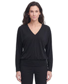 Woman wearing a black long-sleeve top on a white background