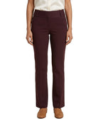 A model wearing a pair of high-waisted, straight-leg trousers in a deep burgundy color, paired with a cream blouse and tan loafers, against a plain white background.