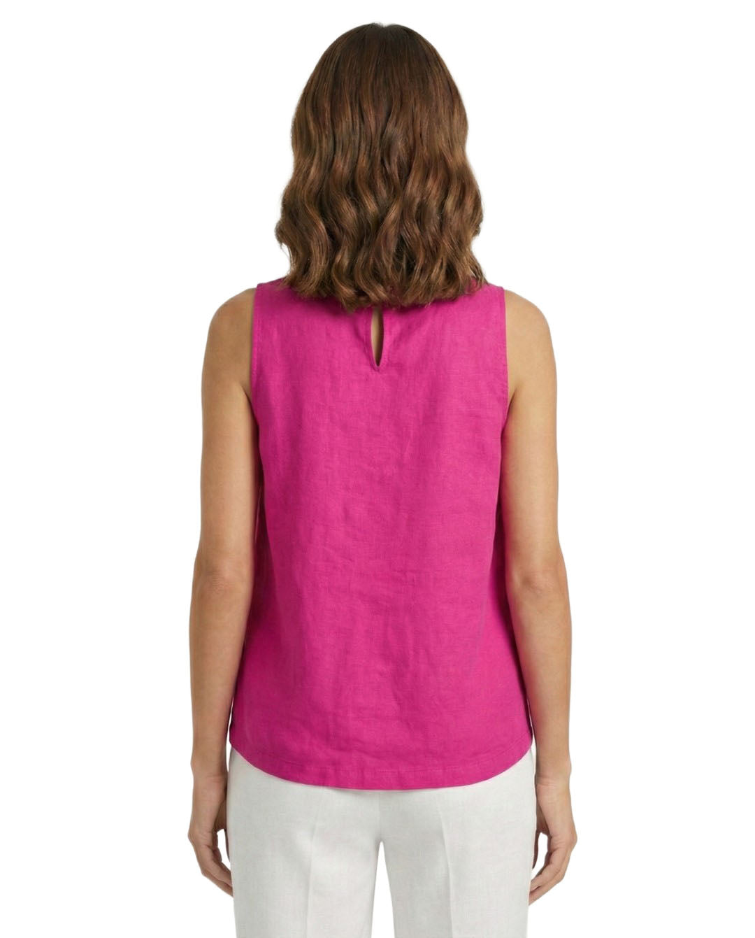 Woman wearing a pink sleeveless top and white pants on a white background