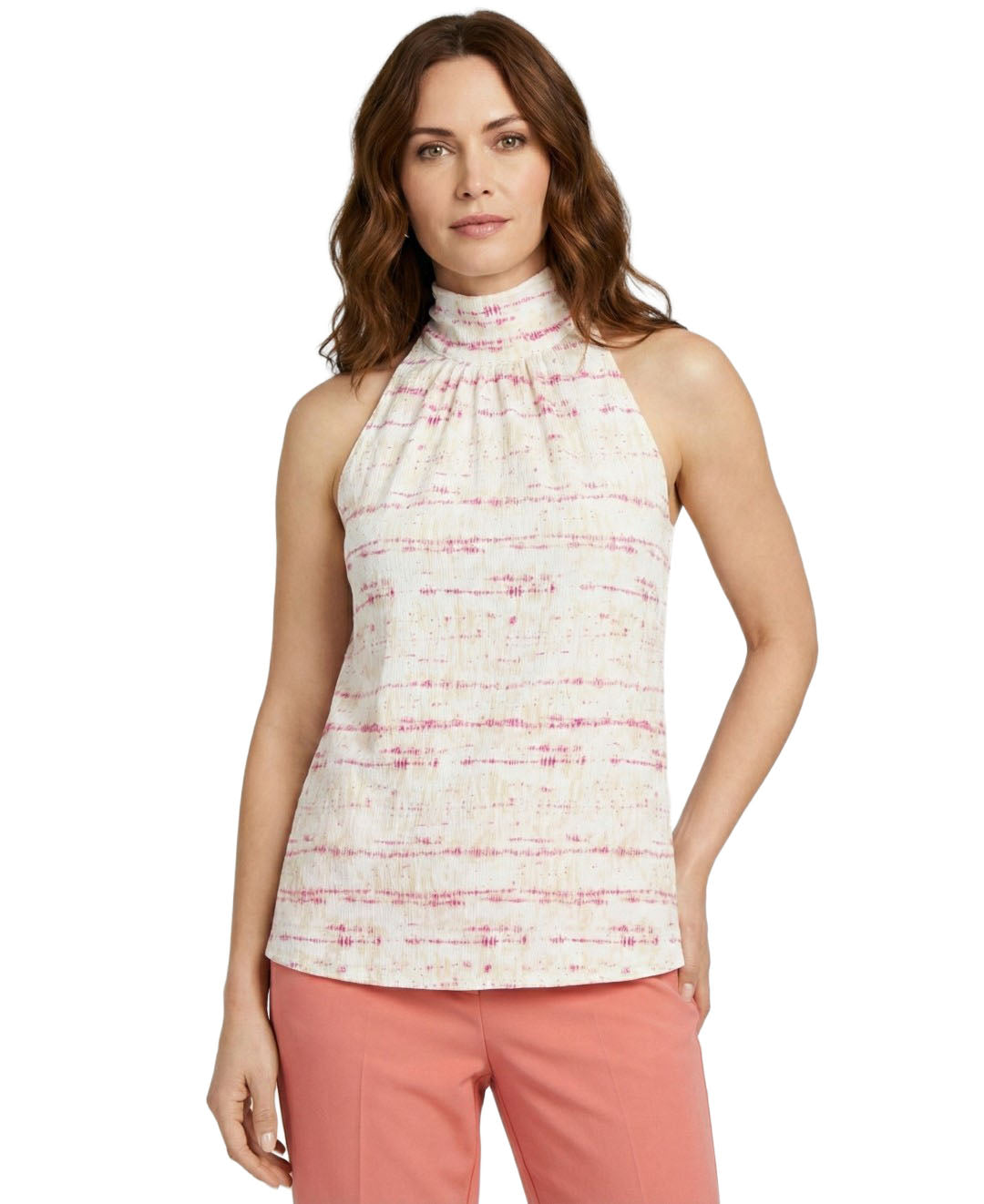 Woman wearing a sleeveless patterned top and pink pants on a white background