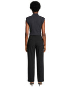 Person wearing a black sleeveless top and black pants on a white background