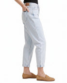 Light blue Calvin Klein jeans worn by a person on a white background