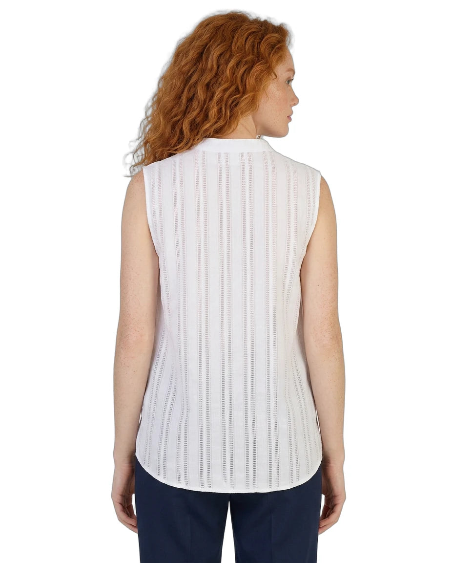 Woman wearing a white sleeveless Calvin Klein blouse with a subtle pattern on a white background