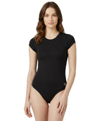 Woman wearing a black bodysuit on a white background