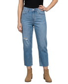 Person wearing light blue jeans with a white background