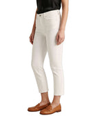 Person wearing white pants and brown shoes on a white background