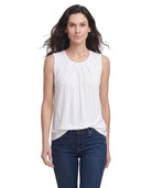 Woman wearing a white sleeveless top and blue jeans on a white background