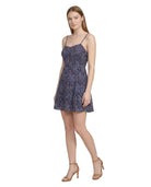 Woman wearing a floral Calvin Klein dress on a white background