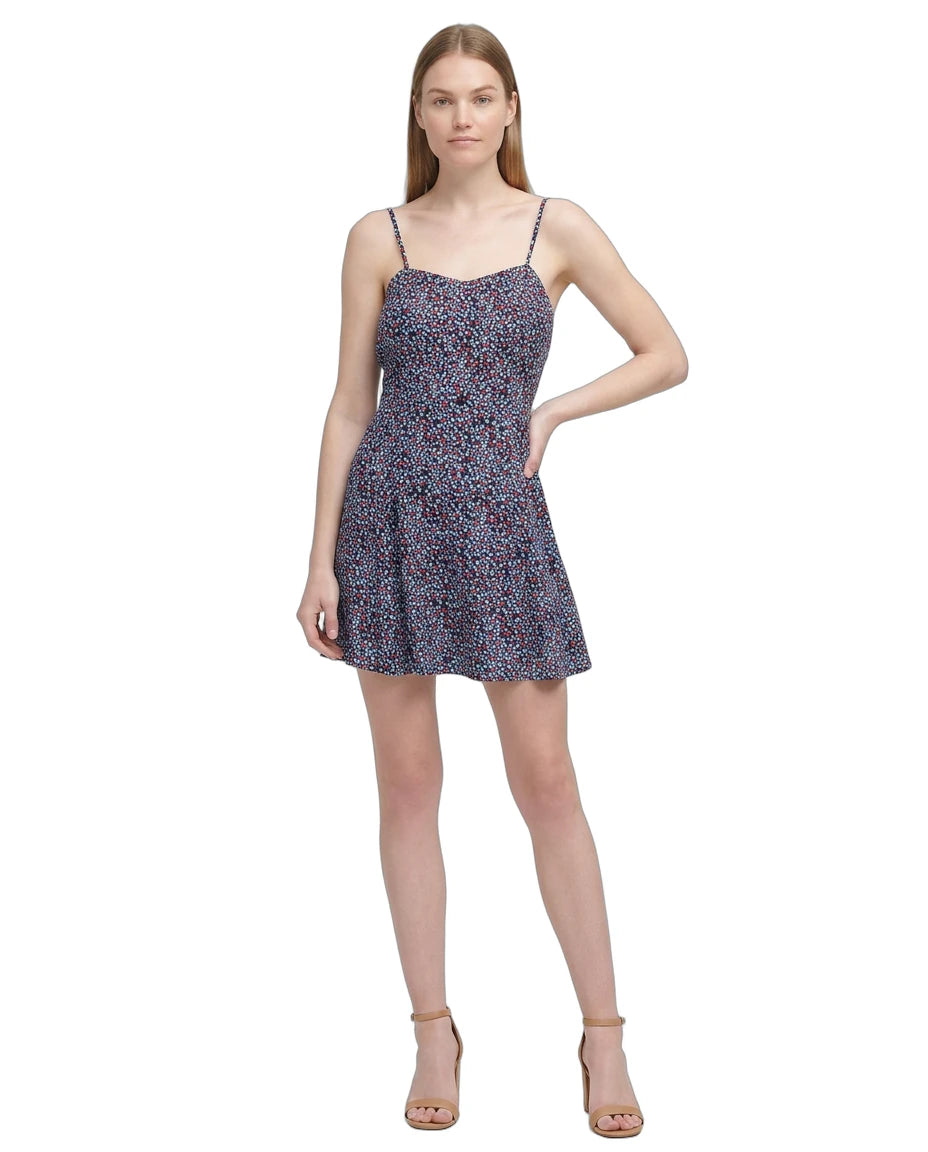 Woman wearing a floral Calvin Klein dress on a white background
