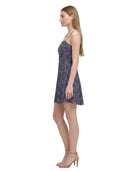 Woman wearing a floral Calvin Klein dress on a white background