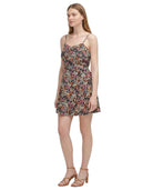 Woman wearing a floral Calvin Klein dress on a white background