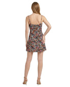 Woman wearing a floral Calvin Klein dress on a white background