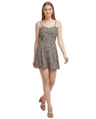 Woman wearing a floral Calvin Klein dress on a white background