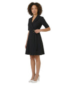 Woman wearing a black dress with a belt on a white background