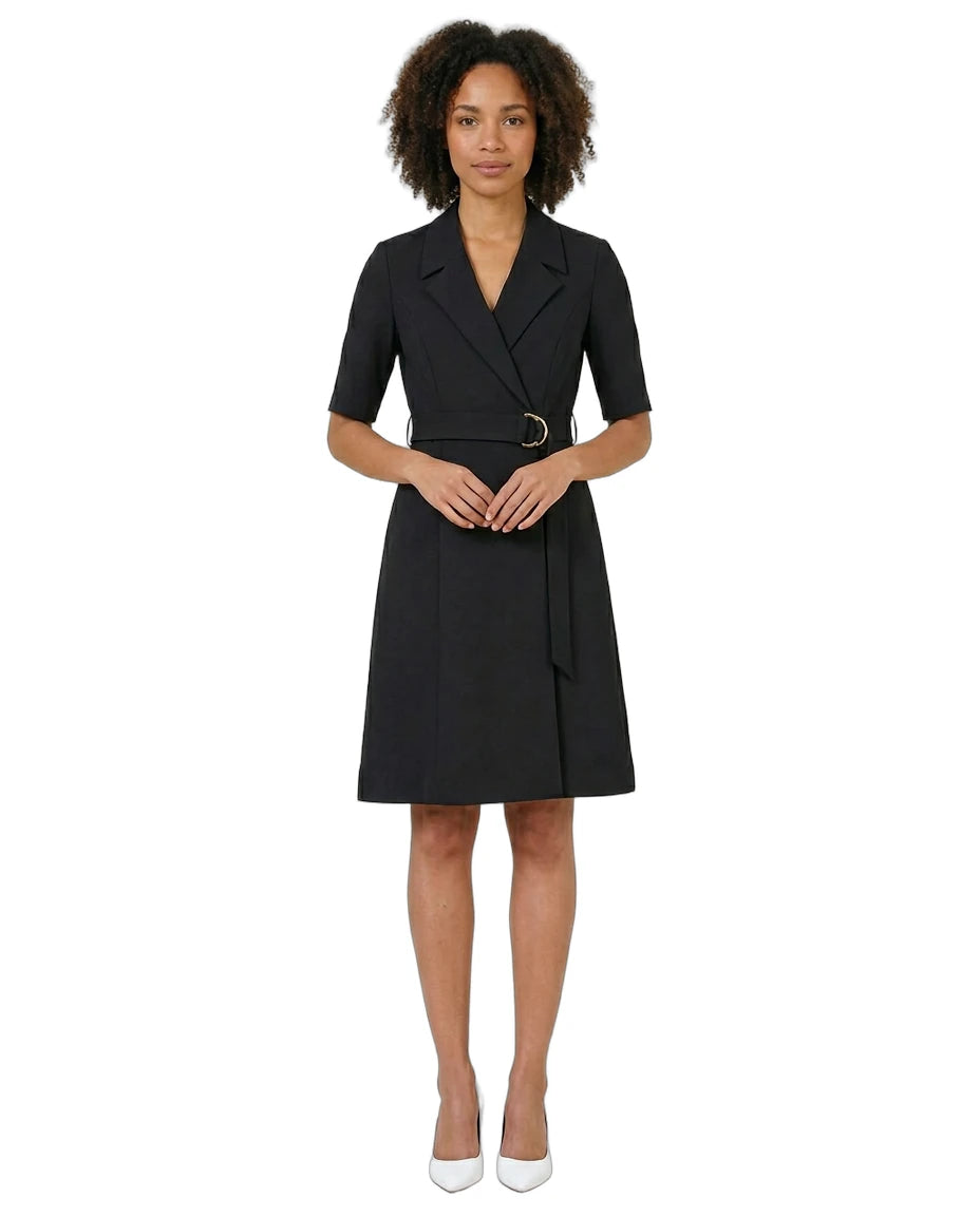 Woman wearing a black dress with a belt on a white background