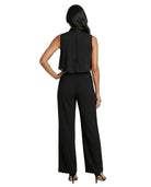 Woman wearing a black sleeveless top and wide-leg pants on a white background