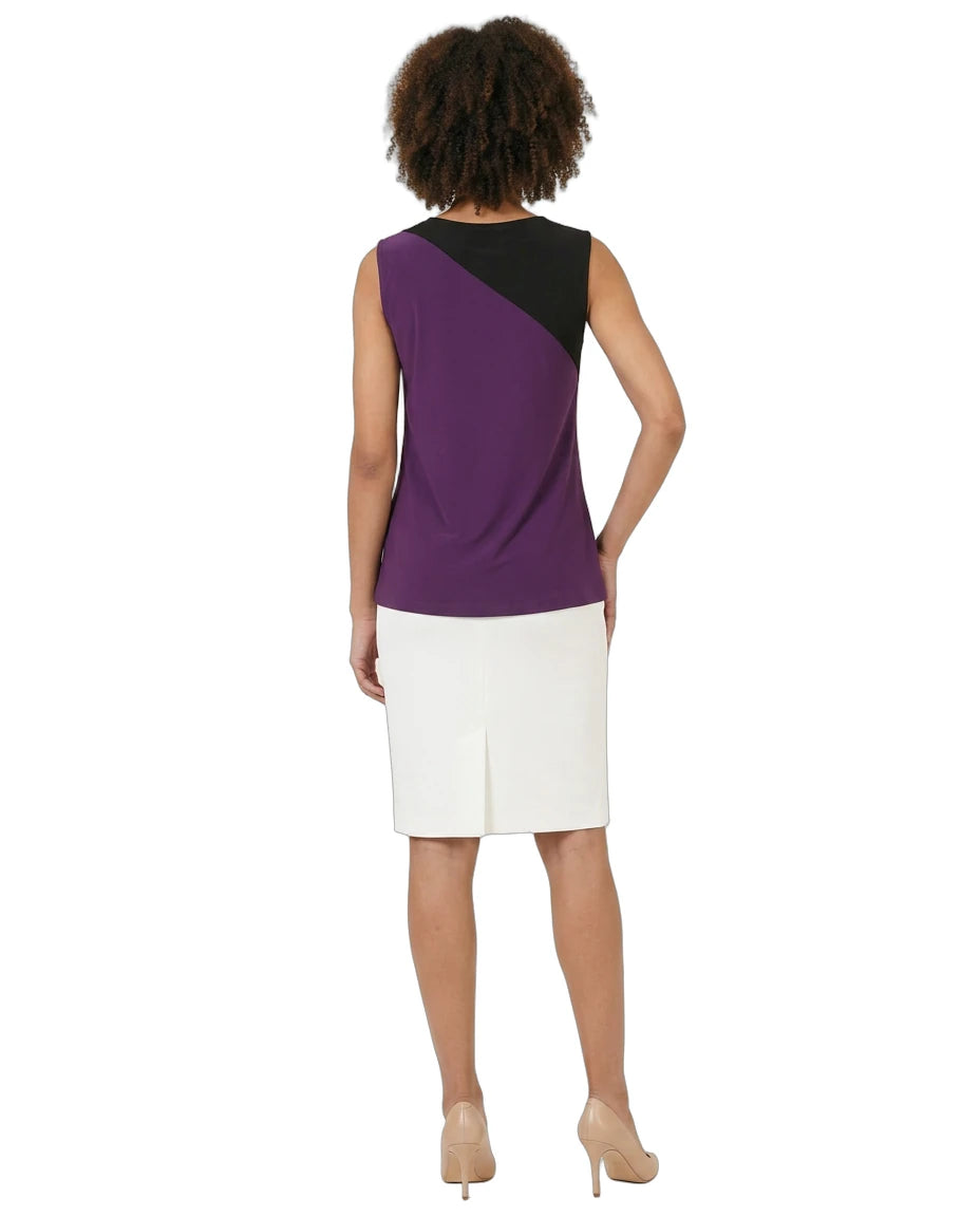 Woman wearing a two-tone dress with purple and black top and white skirt on a white background