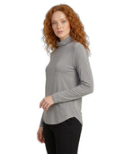 Woman wearing a gray turtleneck sweater on a white background