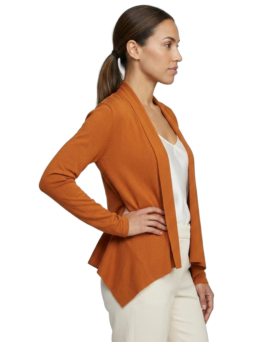Woman wearing an orange Calvin Klein cardigan over a white top on a white background