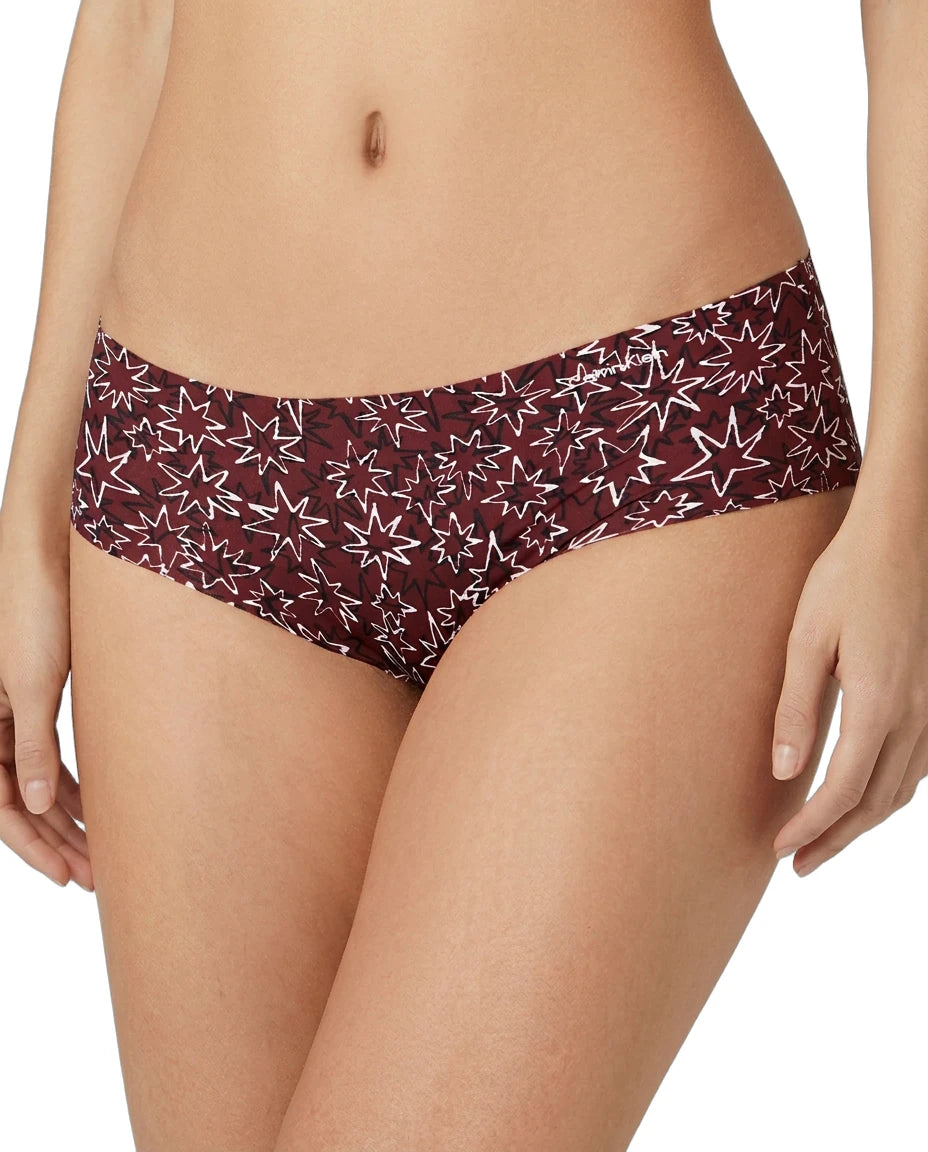 Maroon bikini bottom with star pattern worn by a person on a white background
