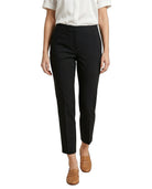 Person wearing black Calvin Klein pants and a white shirt on a white background