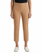 Tan Calvin Klein pants worn by a person on a white background