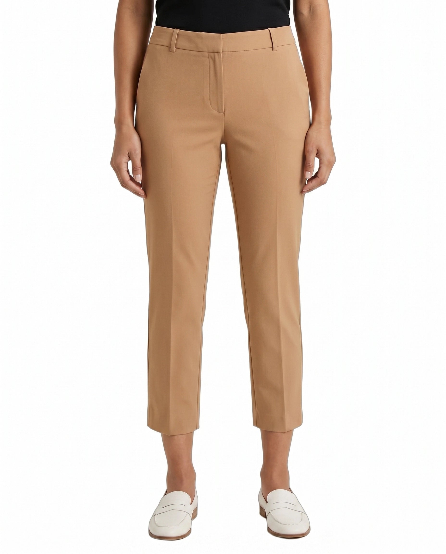 Tan Calvin Klein pants worn by a person on a white background