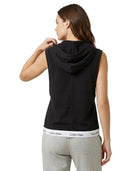 Woman wearing a black sleeveless hoodie with Calvin Klein logo on a white background