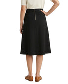 Person wearing a black Calvin Klein skirt on a white background
