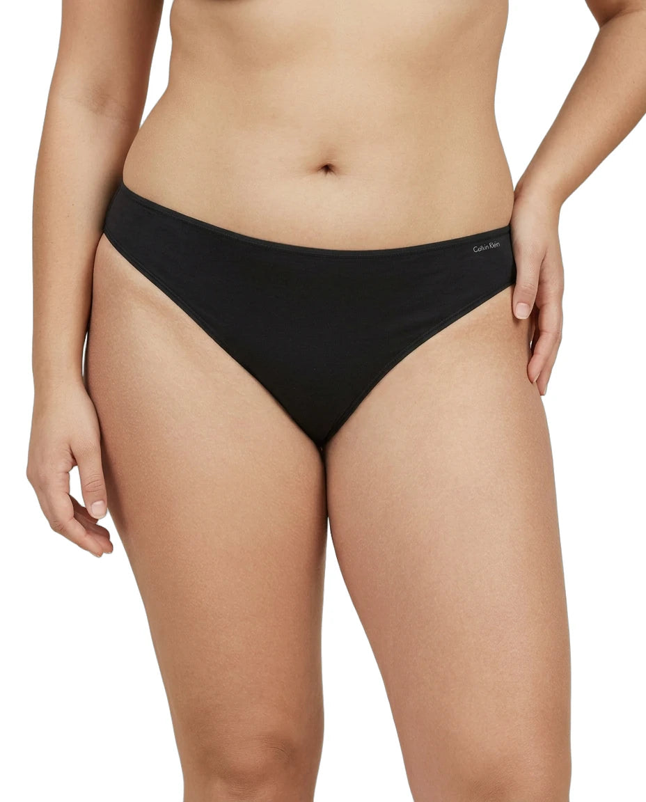 Black bikini bottom worn by a person on a white background