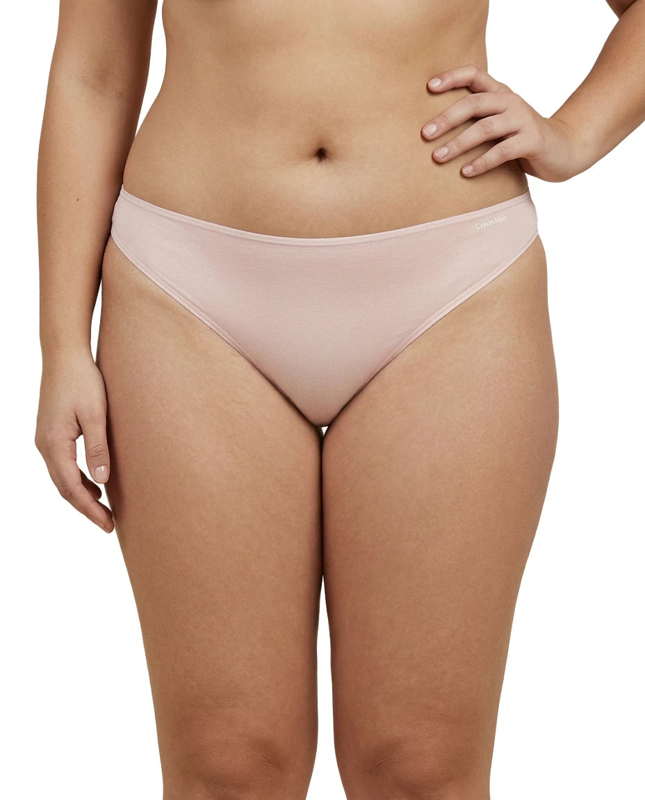 Light pink bikini bottom worn by a person on a white background