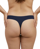 Person wearing a dark blue thong on a white background